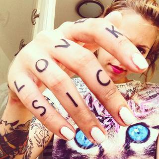 Niewielkie tatuaże na ręce. Formaty skromne i pozbawione akcentów kolorystycznych oraz rozbudowane kształty grafik, które zajmują duże fragmenty dłoni i wykorzystują palce jako np. fragmenty obrazu. 