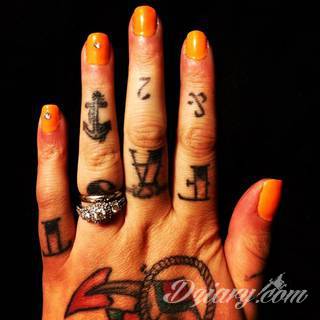 Niewielkie tatuaże na ręce. Formaty skromne i pozbawione akcentów kolorystycznych oraz rozbudowane kształty grafik, które zajmują duże fragmenty dłoni i wykorzystują palce jako np. fragmenty obrazu. 